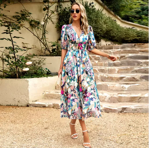 Summer V-Neck Printed Maxi Dress worn outdoors with floral design and stylish accessories.
